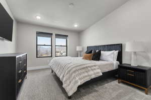 Bedroom featuring light colored carpet and recessed lighting