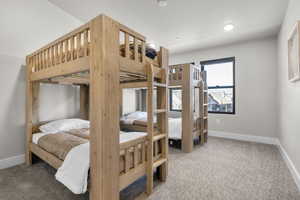 Bedroom with light colored carpet and recessed lighting