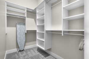 Spacious closet with light colored carpet