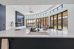 Kitchen featuring modern cabinets, plenty of natural light, recessed lighting, open floor plan, and light stone counters