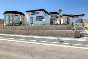 Contemporary house featuring stone siding