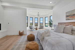 Bedroom with wood finished floors, a chandelier, recessed lighting, and a mountain view