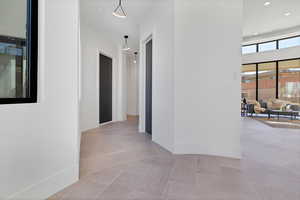 Corridor featuring light tile patterned floors and recessed lighting