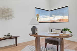 Office space with light wood-style floors and baseboards