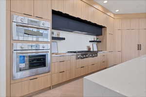 Kitchen featuring light brown cabinetry, open shelves, modern cabinets, and recessed lighting