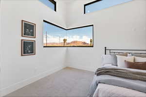Bedroom featuring carpet floors and baseboards