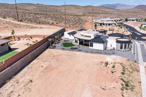 Aerial view of property and surrounding area with a mountainous background