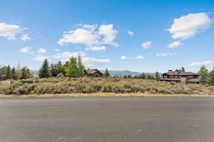View of asphalt street featuring a mountain view