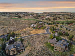 Lot 36 from above as day transitions to night — mountain horizons glowing with color.
