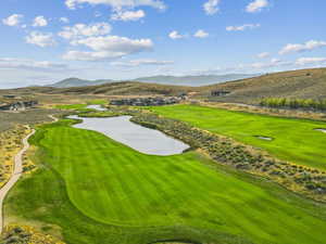 View of community with golf course view and a water and mountain view