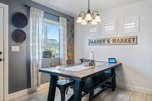 Dining space with wood finish floors, a chandelier, and a mountain view