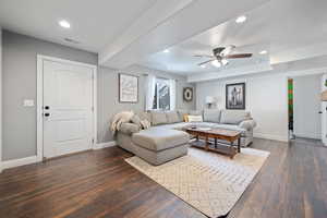 Living room featuring recessed lighting, dark wood-type flooring, a ceiling fan, and a textured ceiling