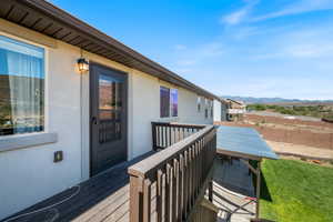 Wooden deck featuring a mountain view and outdoor dining area