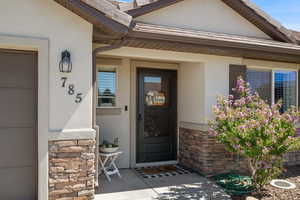 Property entrance featuring stone siding and stucco siding
