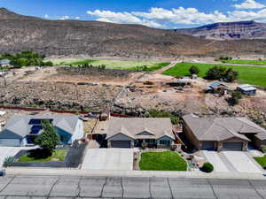 Aerial view of property and surrounding area featuring a mountainous background