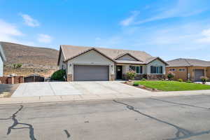 Ranch-style home featuring stone siding, stucco siding, driveway, a garage, and a tile roof
