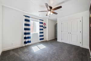 Unfurnished bedroom with carpet, a closet, and ceiling fan