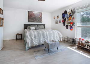 Bedroom featuring wood finished floors and baseboards
