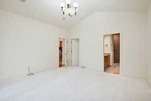 Main Level Primary bedroom with vaulted ceiling, en-suite bathroom and walk-in closet