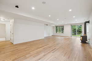 Lower level expansive Living Room with gas fireplace 9' ceilings, walkout, engineered wood floor.