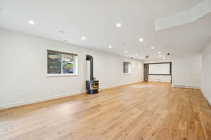 Lower level expansive Living Room with gas fireplace 9' ceilings, walkout, engineered wood floor.