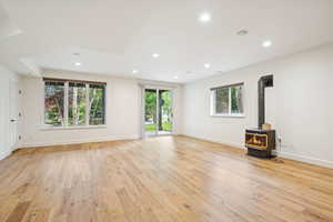 Lower level expansive Living Room with gas fireplace 9' ceilings, walkout, engineered wood floor.