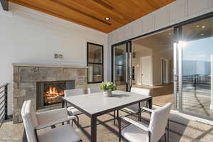 patio featuring an outdoor stone fireplace and outdoor dining space