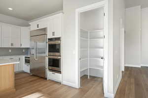 48" refrigerator, drawer microwave, double oven.