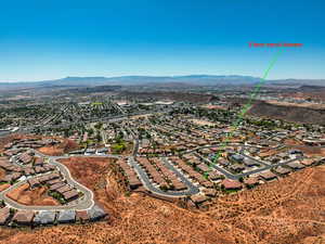 Aerial view of property's location featuring mountains and nearby suburban area