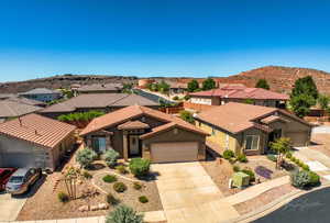 Mediterranean / spanish-style house with a residential view, driveway, stucco siding, a garage, and a mountain view