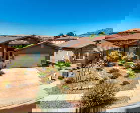 Mediterranean / spanish-style house with stucco siding, driveway, a garage, and stone siding
