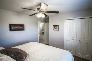 Bedroom with ceiling fan and a closet