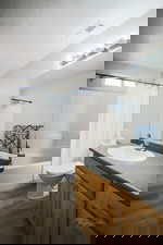 Full bathroom featuring vanity, shower / bath combination with curtain, dark wood finished floors, and a textured ceiling