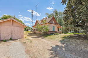 View of property exterior with a shed and a chimney