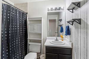Bathroom with a shower with curtain, vanity, and a textured ceiling