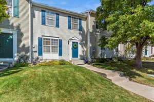 Colonial inspired home with entry steps and a front yard