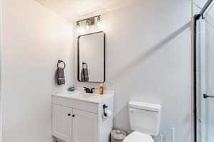 Full bathroom featuring vanity and a stall shower