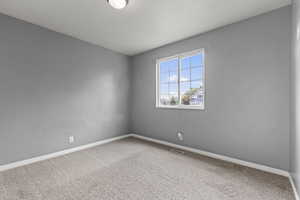 Unfurnished room featuring carpet floors and baseboards