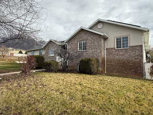 View of front facade with brick siding and stucco siding