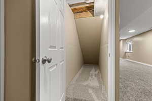 Stairs with carpet flooring and lofted ceiling