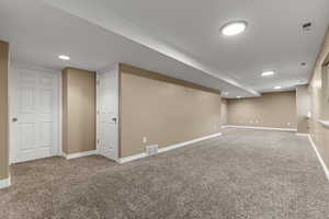 Finished basement featuring carpet floors and recessed lighting