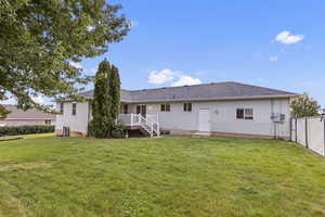 Back of property featuring roof with shingles and a wooden deck