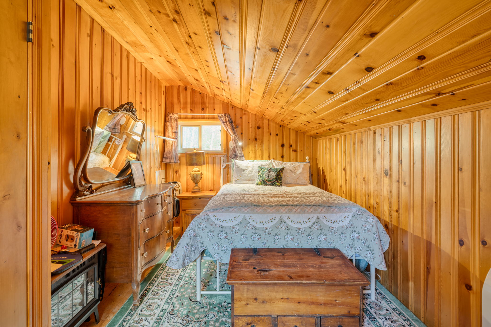 Bedroom featuring wooden walls, lofted ceiling, wood ceiling, and wood finished floors