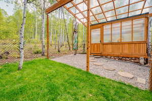 View of yard with a greenhouse and an outbuilding