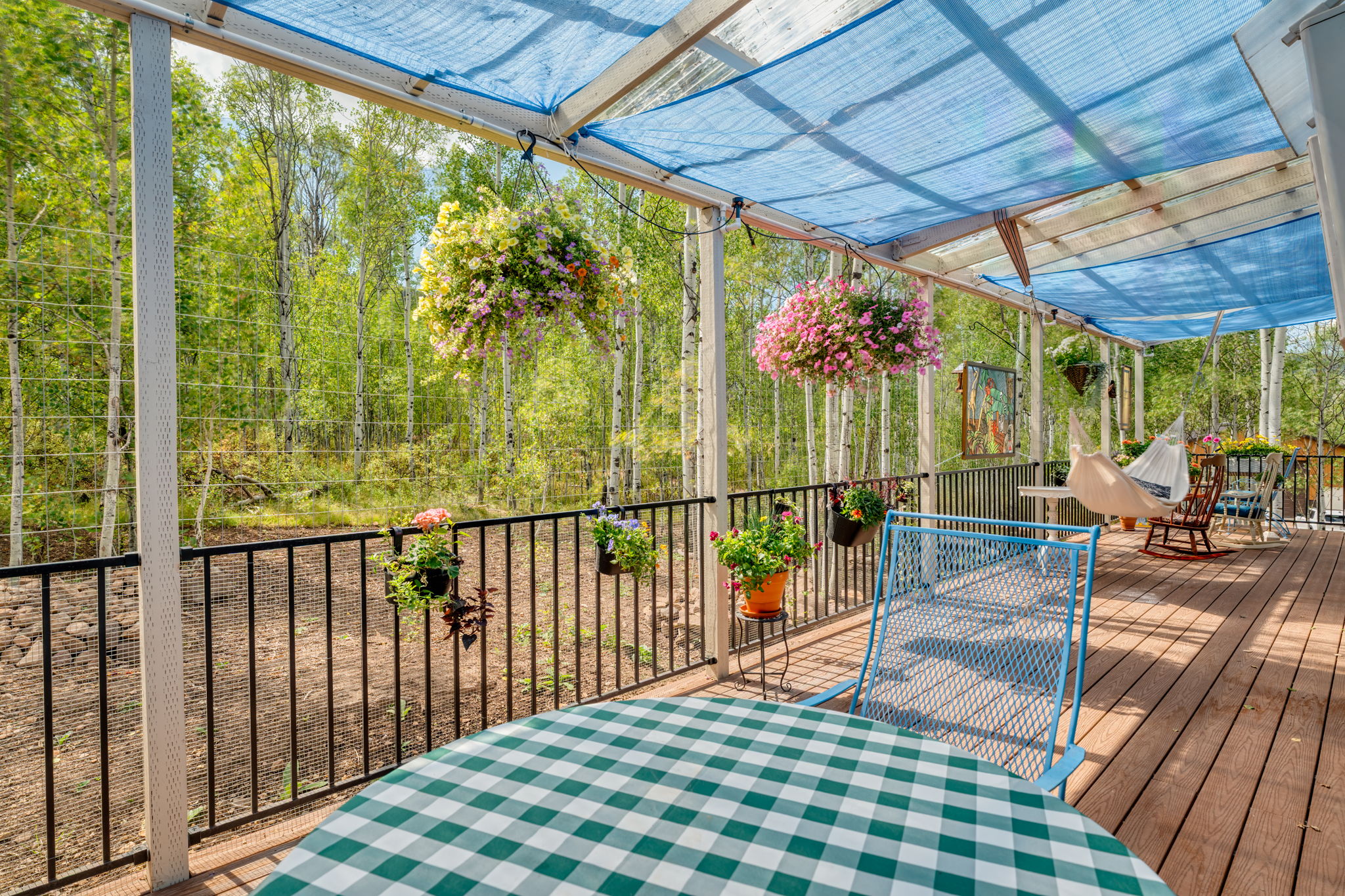 Wooden terrace with view of wooded area