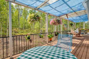 Wooden terrace with view of wooded area