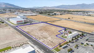 Aerial overview of property's location featuring property boundaries highlighted and a mountainous background