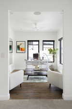 Living room with a desk and hardwood / wood-style flooring