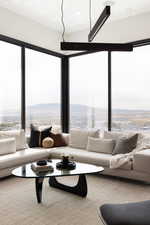 Living room with a mountain view and light carpet