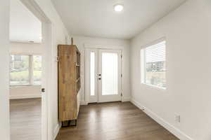 Entrance foyer with baseboards and light wood-type flooring